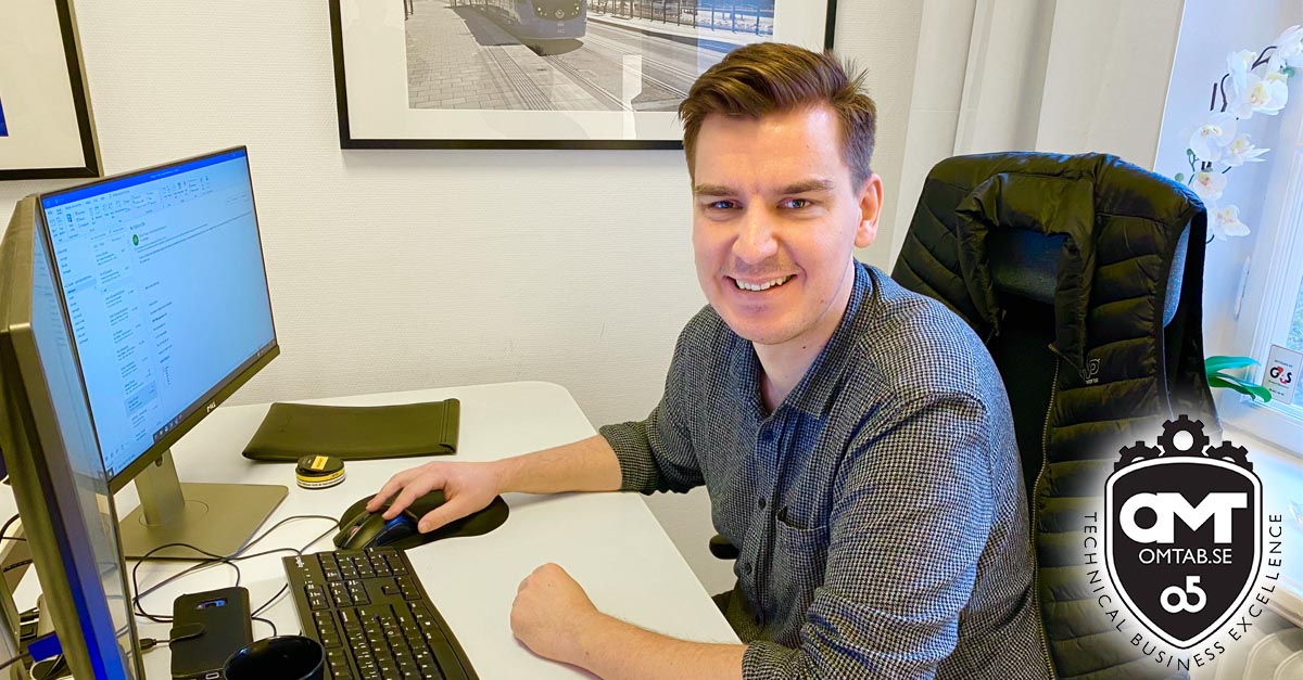 Co-worker at office desk behind computer.