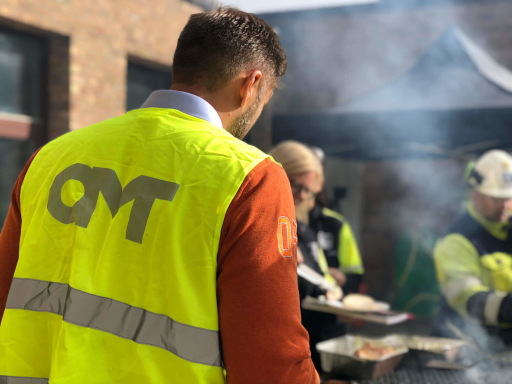 Personer i OMT-västar grillar